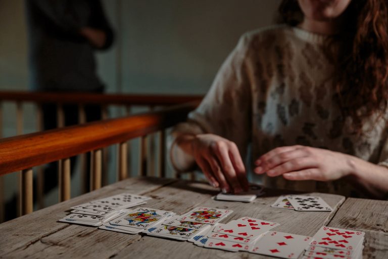 Lady playing patience game with branded playing cards